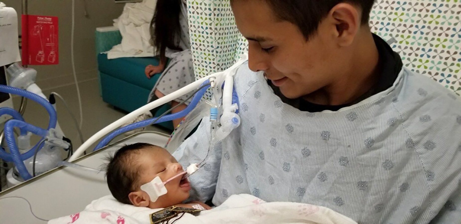 Yovany Lopez holds his son